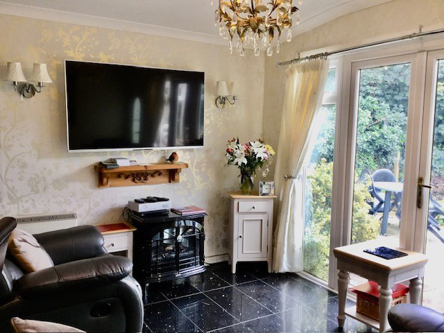 Lounge with large screen TV at Hollyhocks Bungalow Holiday Accommodation Welcombe North Devon